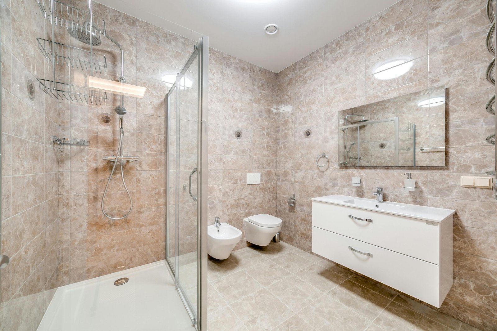 A bathroom with a shower, sink and toilet